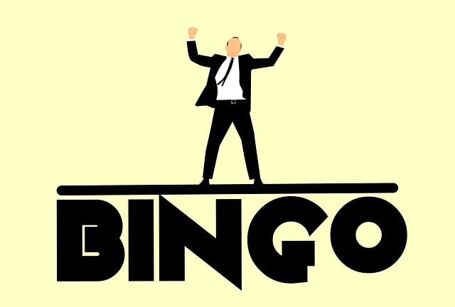 A man in a suit celebrating on top of the word 'Bingo'